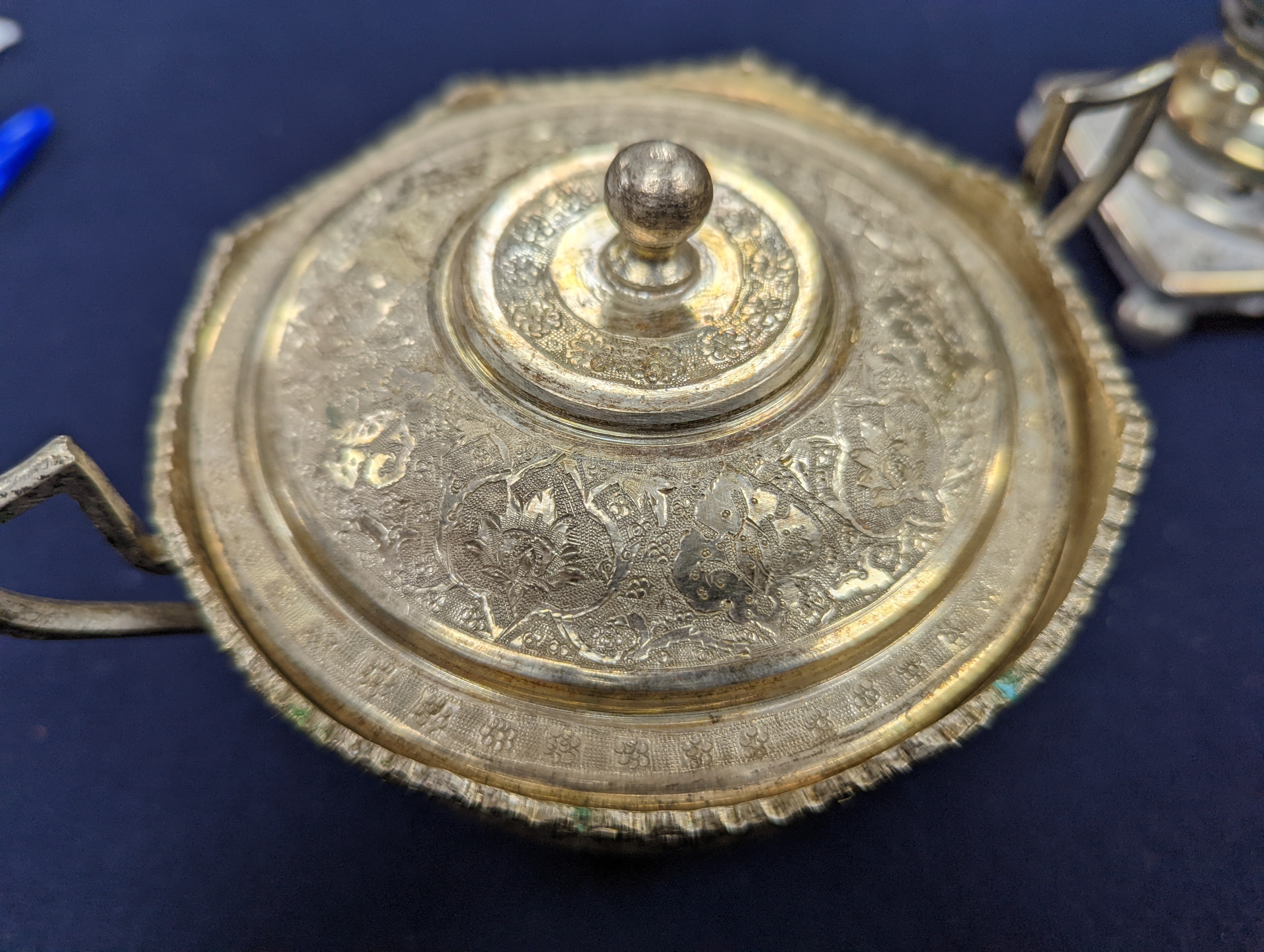 A set of six Persian embossed 84 standard white metal coffee cup holders and matching sugar bowl and cover by Vartan and four other Persian white metal items.